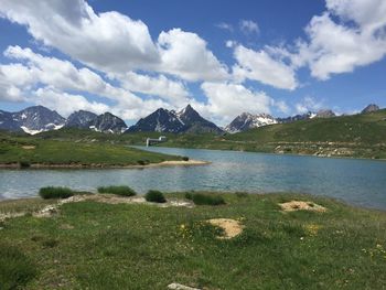 Scenic view of lake and mountains against sky