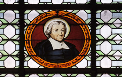 Close-up portrait of cross on glass window