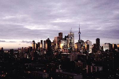 View of cityscape against cloudy sky