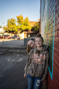 Portrait of a smiling girl standing outdoors