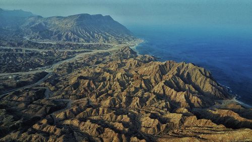 Aerial view of mountain and sea against sky