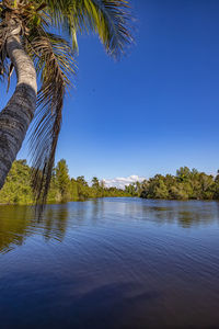 Scenic view of lake against clear blue sky