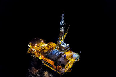 High angle view of illuminated lighting equipment against black background