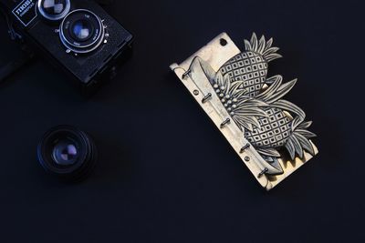 High angle view of camera on table against black background