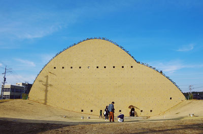 People walking in front of historical building