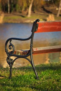 Close-up of empty bench on field