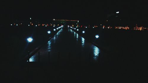 Illuminated tunnel at night