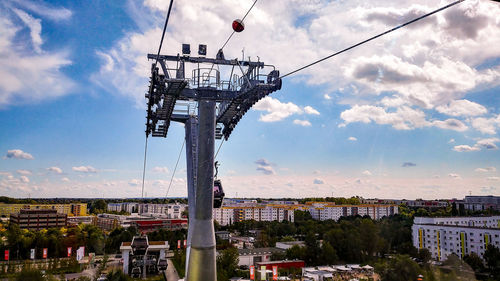 Cranes against sky in city