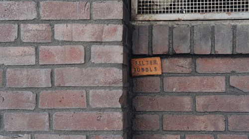 Close-up of text on brick wall