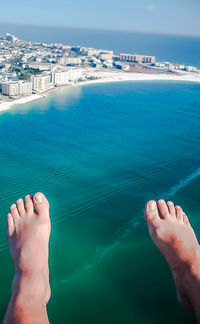 Low section of man legs against sea