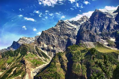 Scenic view of mountains against cloudy sky