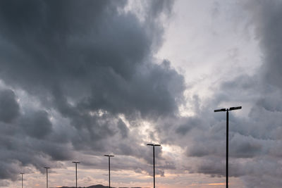 Low angle view of street light against cloudy sky