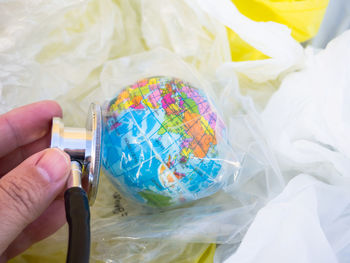 Midsection of person holding multi colored candies