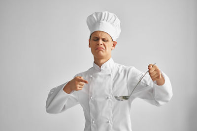 Chef standing against white background