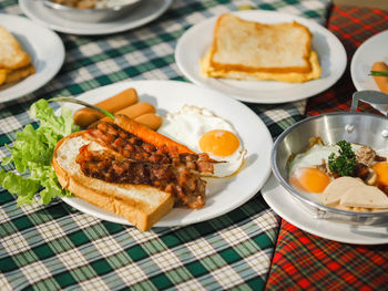 Morning time ,eat breakfast bacon toasted bread , sausage ,eggs and vegetable baby carrot