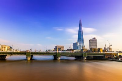 Bridge over river with buildings in background