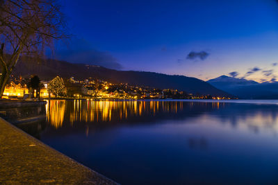 Scenic view of lake against sky at night