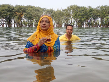 Woman and man at tanguar wetland of sunamganj in bangladesh