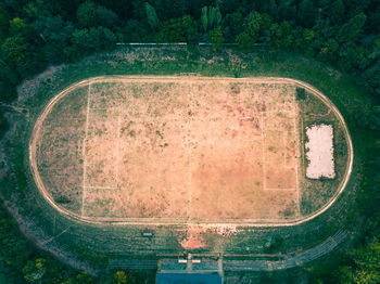 High angle view of road amidst trees on field