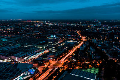 High angle view of illuminated city against sky at dusk