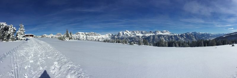 Snow covered landscape against sky