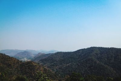 Scenic view of mountains against clear blue sky