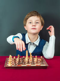 Portrait of boy playing chess