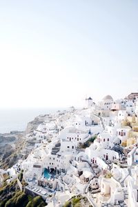 High angle view of town by sea against clear sky