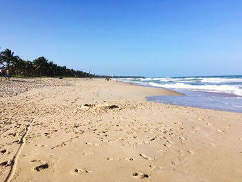 Scenic view of beach against clear sky