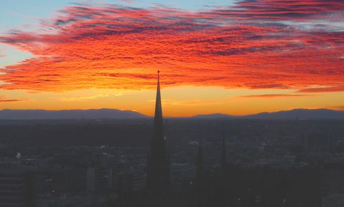 Clouds over city at sunset