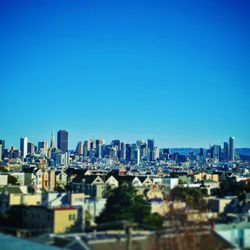 Cityscape against clear blue sky