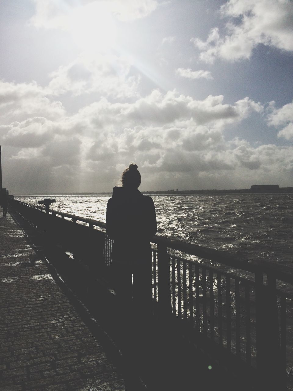 water, sky, sea, rear view, cloud - sky, standing, horizon over water, silhouette, railing, leisure activity, lifestyles, men, tranquility, tranquil scene, cloud, full length, looking at view, nature