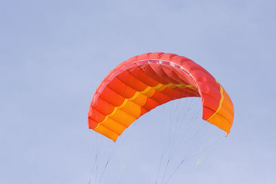 Low angle view of parachute against sky