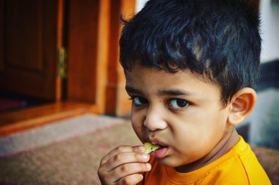 Close-up portrait of boy eating food