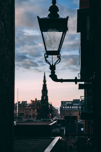 Street light and buildings against sky