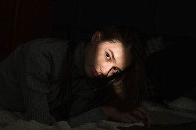 Portrait of woman sitting at home