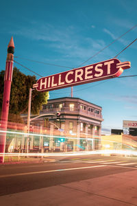 Low angle view of road sign at night