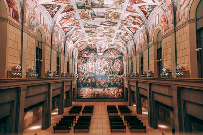 Illuminated chandelier hanging from ceiling