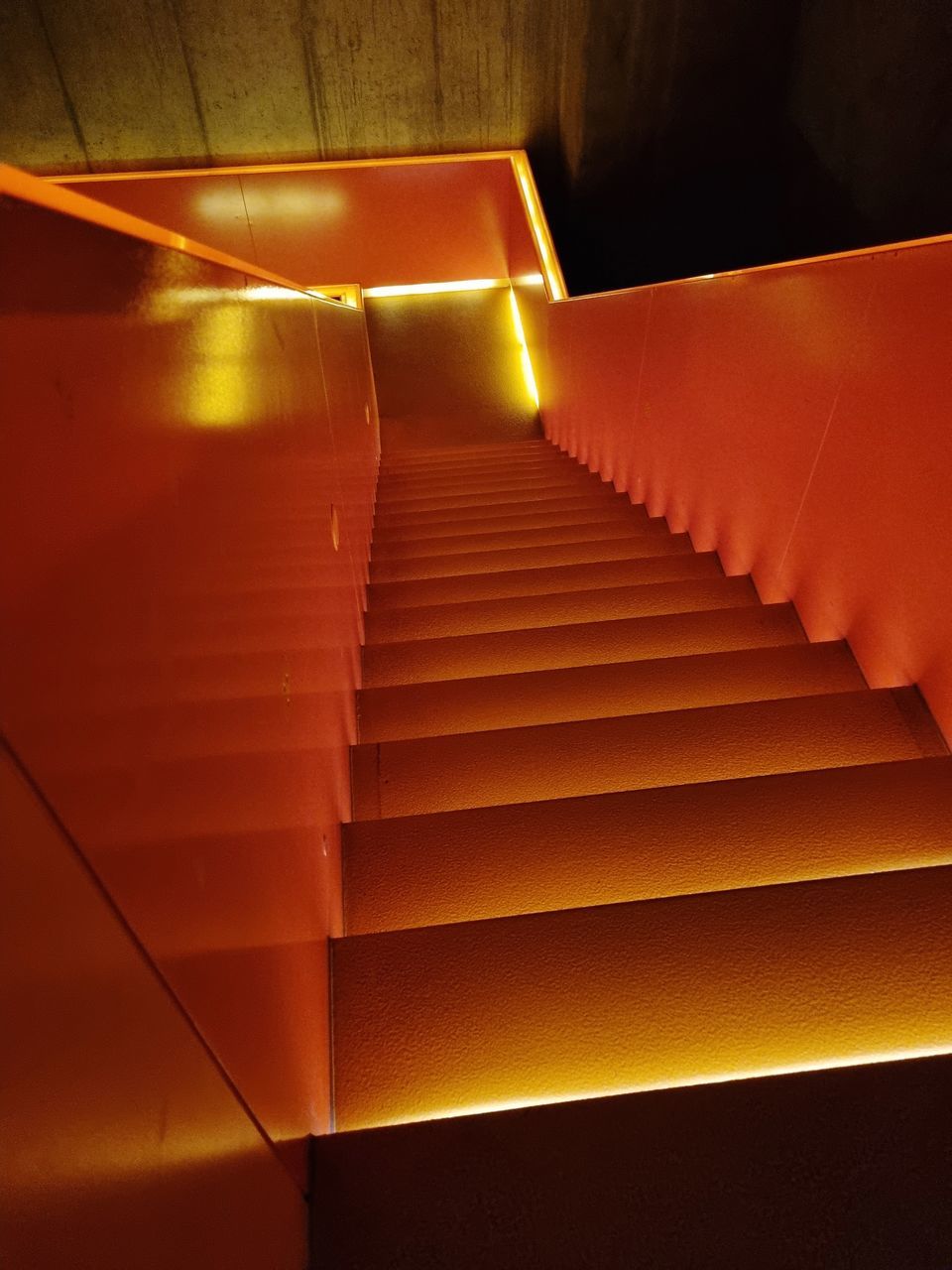 yellow, light, red, staircase, steps and staircases, orange, architecture, indoors, stairs, no people, illuminated, line, night, ceiling, pattern, built structure, orange color, lighting, lighting equipment, wall - building feature
