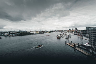 High angle view of cityscape by sea against sky