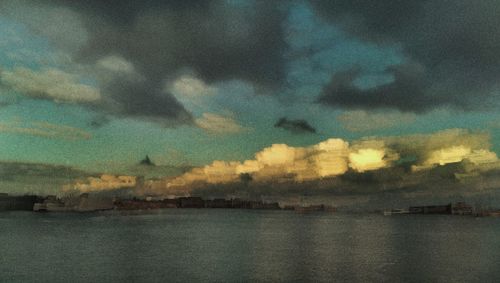 Scenic view of river against sky at sunset