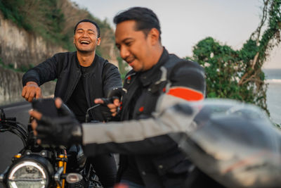 Portrait of man riding motorcycle on road
