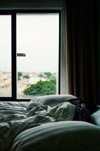 Boy sleeping on bed at home