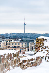 Vilnius city view with tv tower on background in winter day with snow, view form the castle