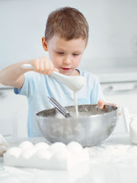 High angle view of cute baby boy preparing food