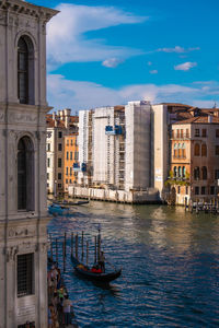 High angle view of venice city with gondola boat passing through the canals.