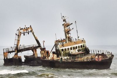 Ship sailing in sea against clear sky