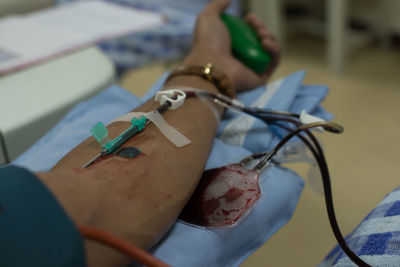 Cropped hand of patient with iv drip in hospital