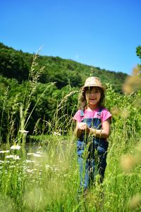 Portrait of smiling woman standing on field