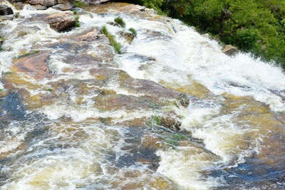 High angle view of water flowing through rocks